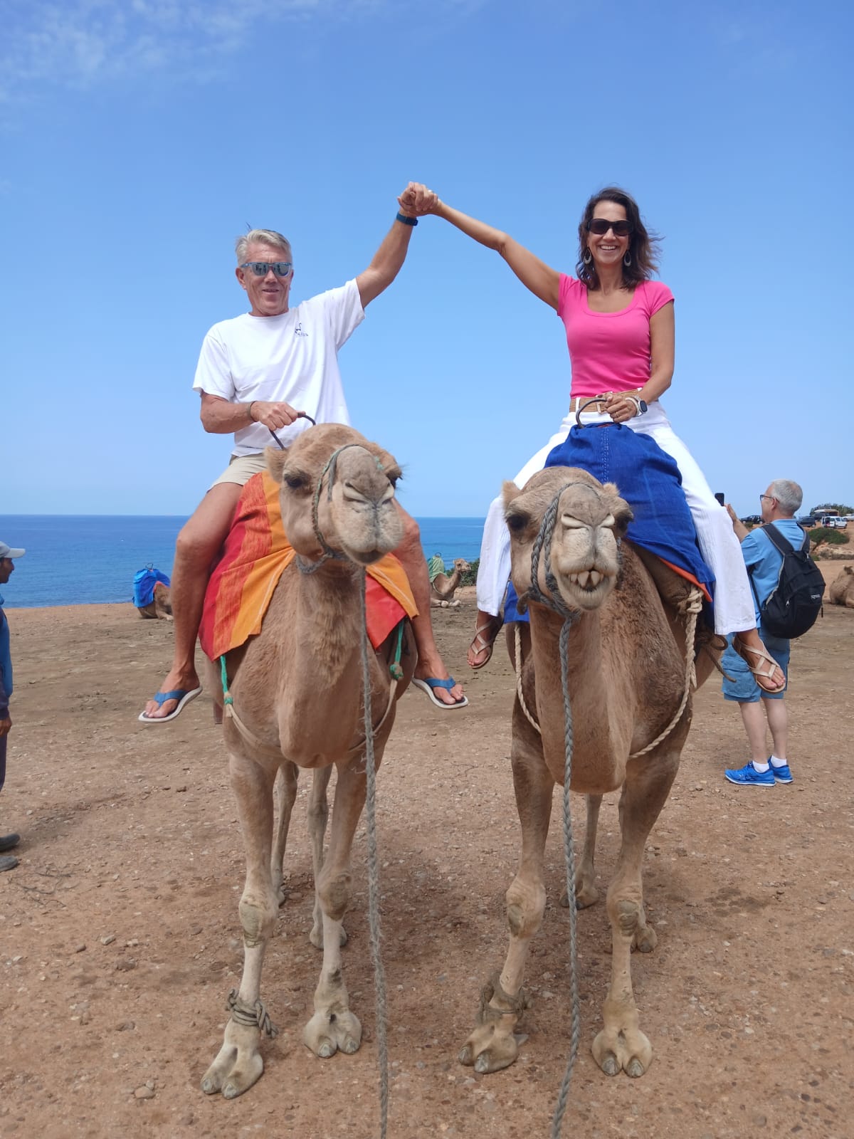 Couple enjoying a romantic camel ride along the Moroccan coast