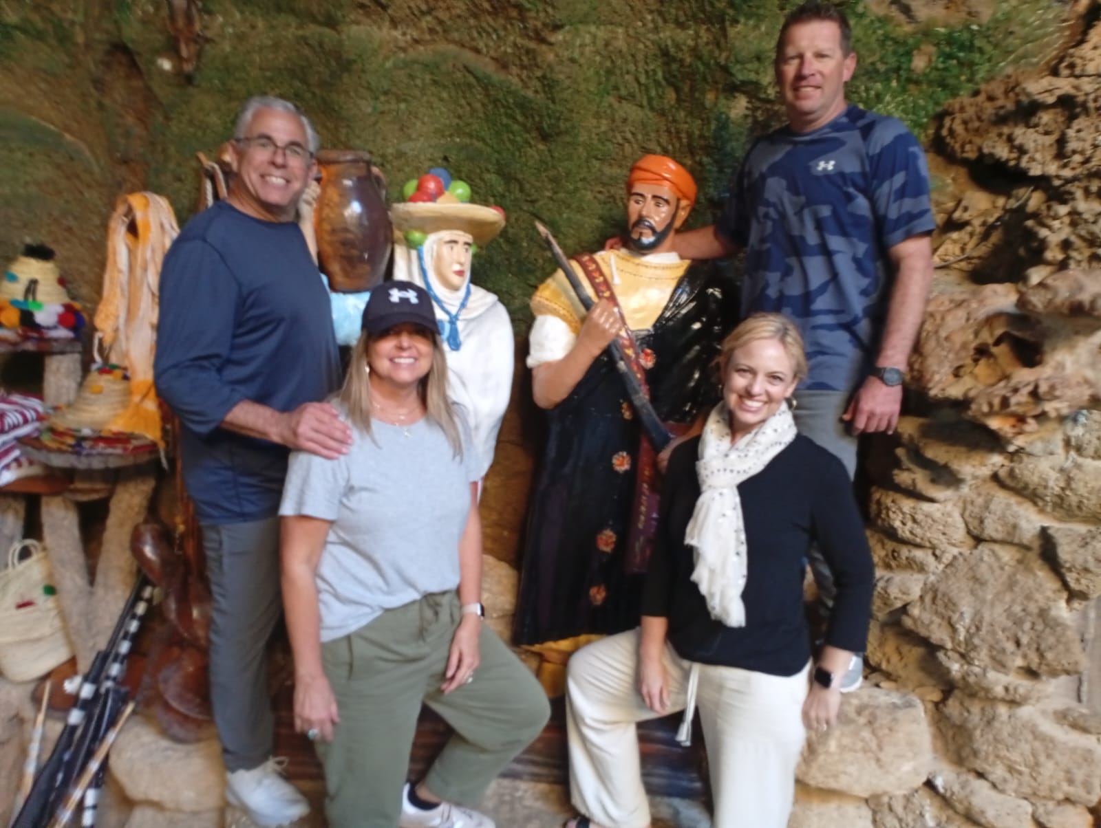 Tourists with traditional Moroccan statues in a cave setting