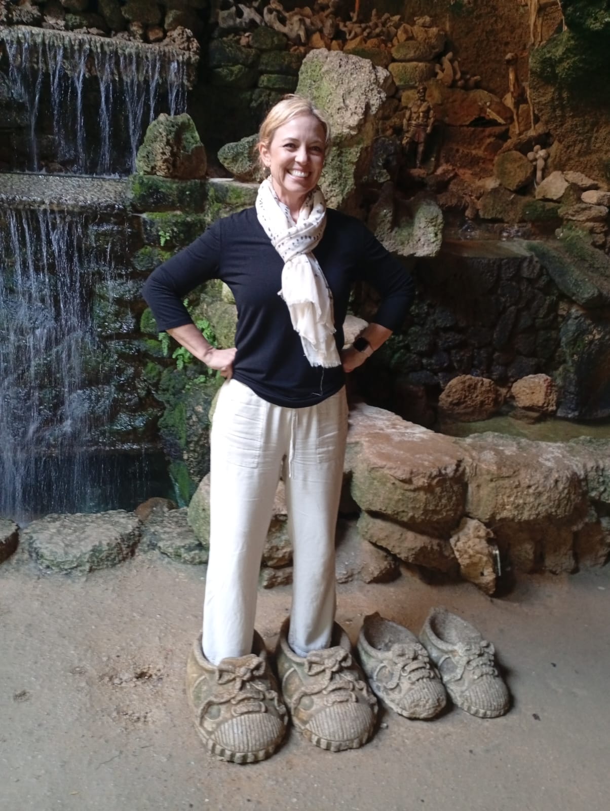 Tourist at a cave with natural waterfall in Morocco