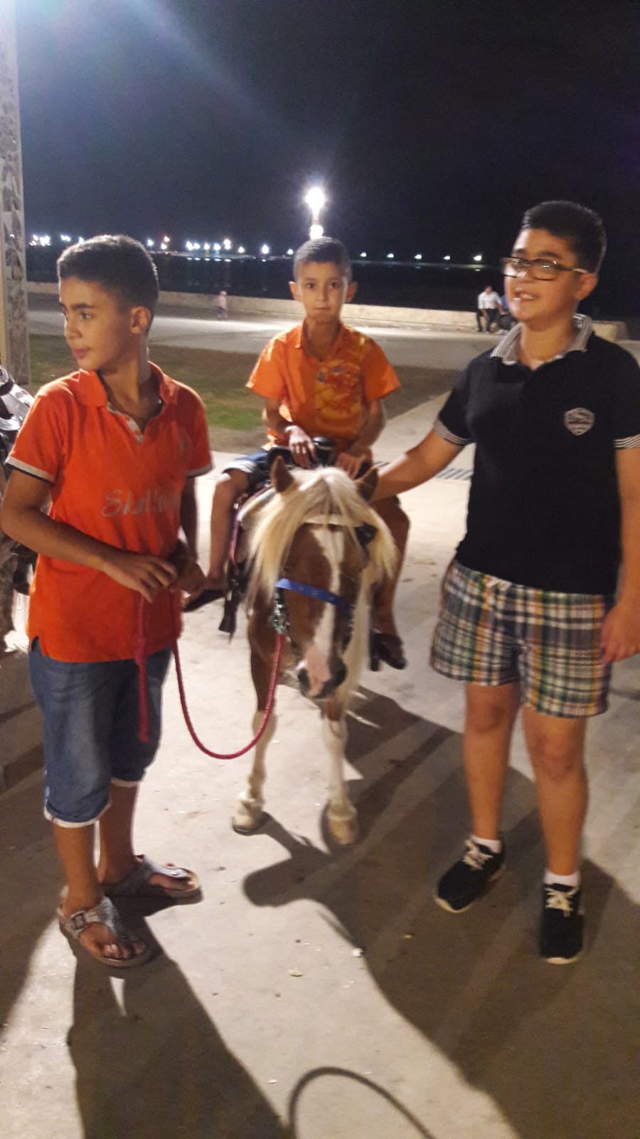 Children with a pony during an evening tour in Tangier