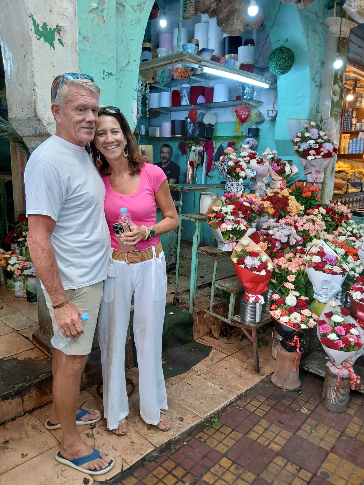 Tourists exploring a colorful Moroccan flower market