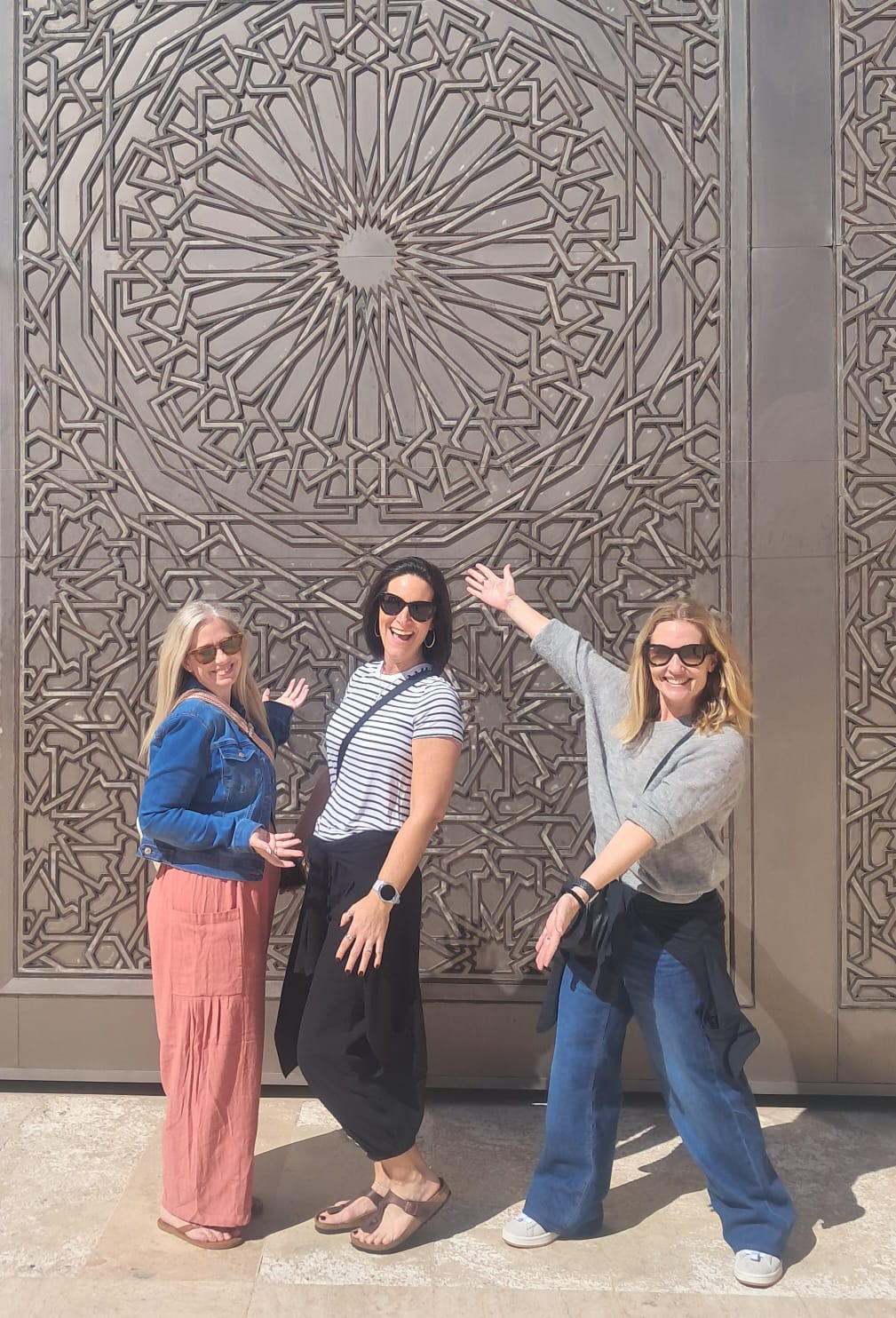 Tourists posing with beautiful Islamic geometric patterns