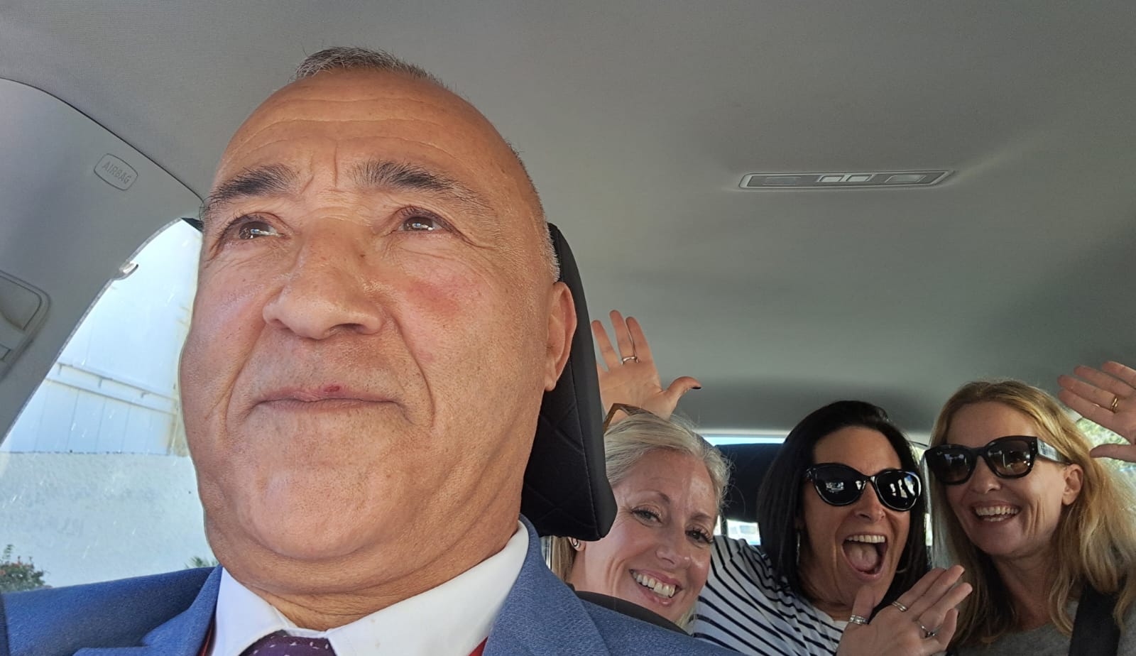 Hamid with happy tourists in his vehicle