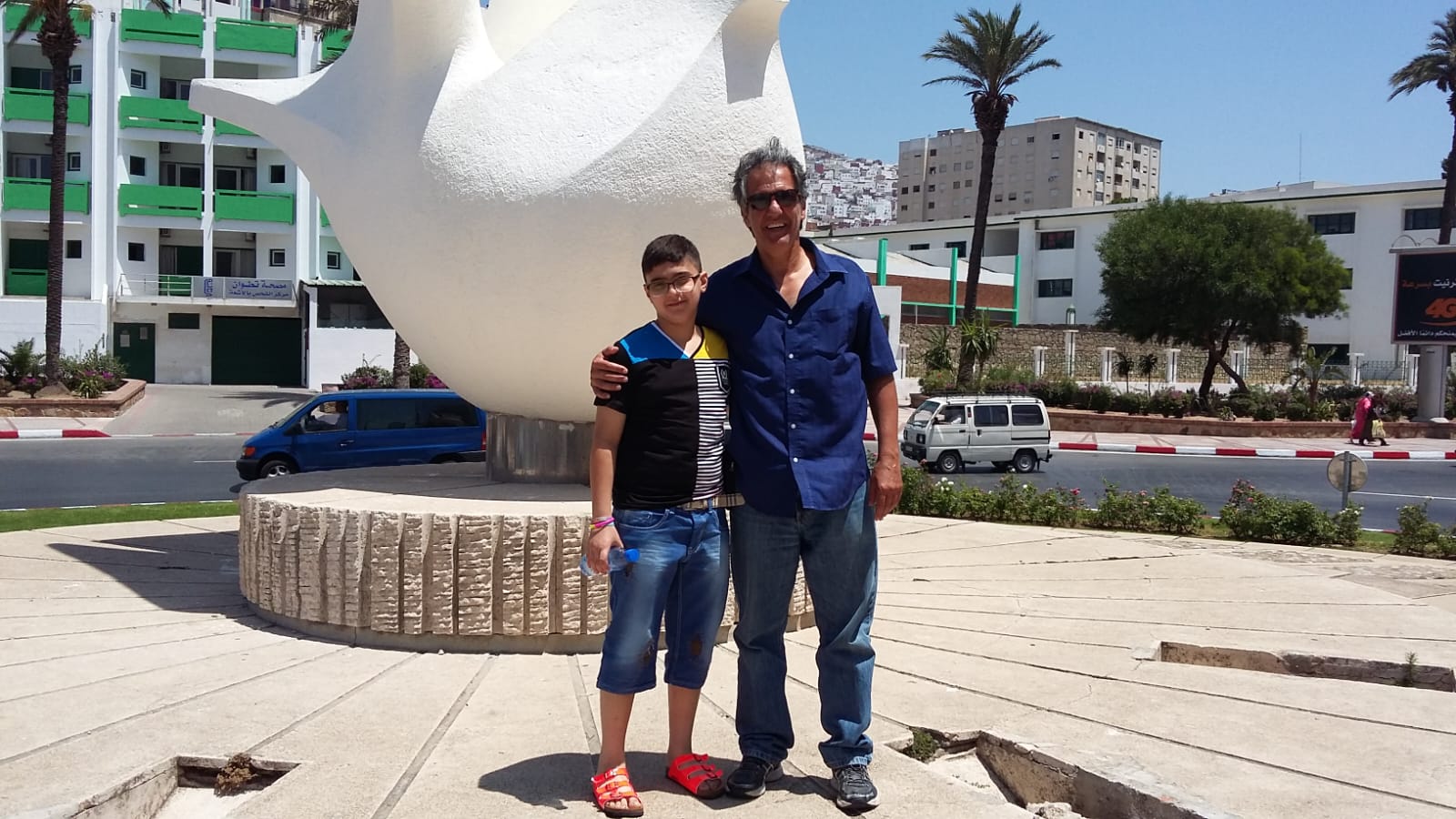 Tourist and child visiting a modern monument in a Moroccan city